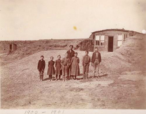 family standing in front of sod house Thomas County Kansas